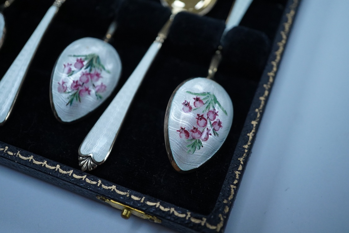 A cased set of six silver gilt and enamel coffee spoons, Adie Brothers, Birmingham, 1966, together with two other cased sets of coffee spoons including a mother of pearl set and a silver set.